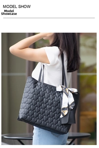 Detail of heart quilted tote bag with silk scarf and matching coin purse on model