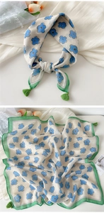 Detail of floral cotton linen square scarf with blue blossoms and green corner tassels