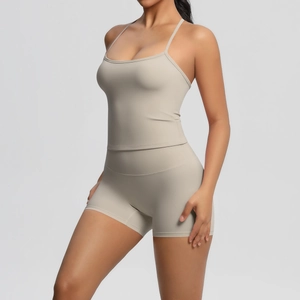 Detail view of the beige sports camisole and high-waisted shorts on a model