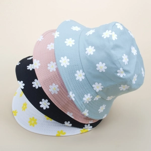 Daisy embroidered reversible bucket hats in light blue, pink, black, and white colors