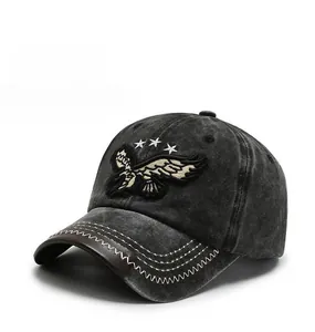 Close-up of eagle embroidery and contrast stitching on washed black baseball cap
