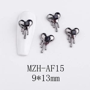 Macro detail of lava-style heart nail charm with black square rhinestone and 9x13mm scale