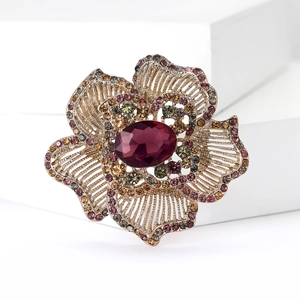 Macro detail of a vintage flower brooch with purple gemstones and colorful rhinestones