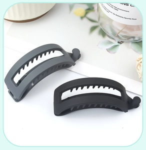 Macro shot of matte grey and black banana hair clips with professional styling detail