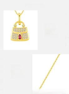 Detailed macro shot of an s925 silver handbag pendant with sparkling zircons and red teardrop
