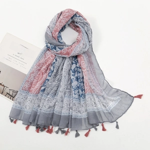 Detail of vintage floral voile shawl with delicate handmade tassels and soft fabric
