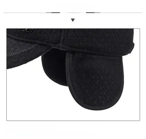 Detail view of the black winter ear protection cap with windproof fabric and visor