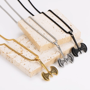 Three-color battle axe necklaces in gold, silver, and black finish with engraved details