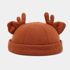 Detail of caramel docker hat featuring 3D reindeer antlers and ears in cotton knit
