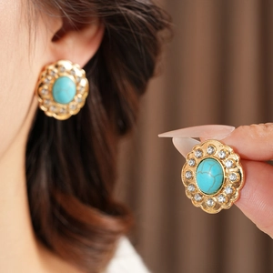Détails des boucles d'oreilles vintage dorées avec turquoise et strass étincelants