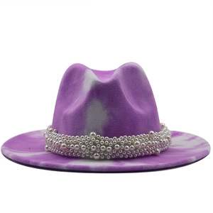Detail of purple tie-dye fedora hat featuring elegant white pearl woven band embellishment