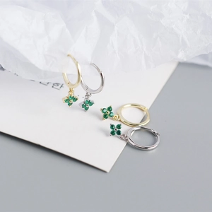 Detail of S925 sterling silver hoop earrings with green clover crystal pendants