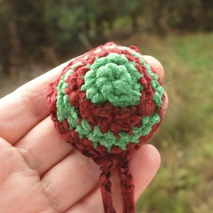 Detailed macro view of a hand-knitted Christmas red and green wool yarn nose warmer