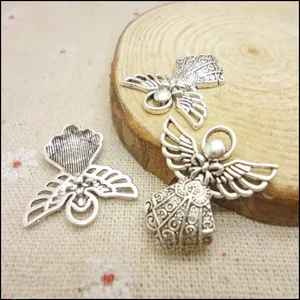 Detailed view of vintage silver angel charm with intricate hollow wings and hanging ring