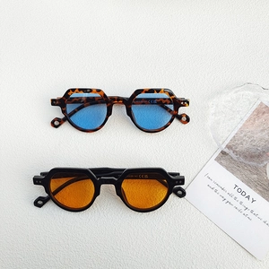 Vintage small round sunglasses with tortoise blue and black orange lenses on white background