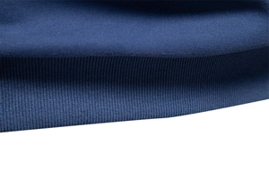 Macro detail of navy blue knitted cotton polo sweatshirt showing ribbed hem stitching