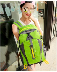 Close-up of bright green waterproof nylon hiking backpack with vertical zipper pocket