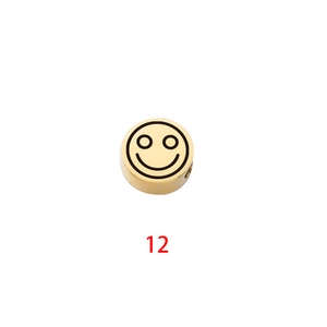 Detail of golden stainless steel cylinder bead featuring a laser-engraved smiley face design