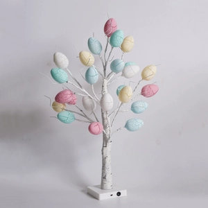 Close-up of Easter egg tree light with birch texture trunk and colorful cracked eggs
