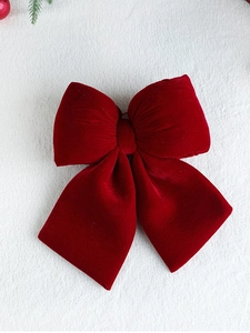 Detailed view of a large red velvet decorative bow for Christmas tree decoration