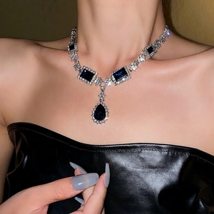 Elegant silver necklace featuring blue teardrop and square gems with micro-pave crystals