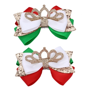 Detail of Christmas hair clips with red and green sequined bows and golden crown