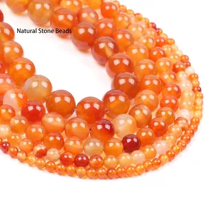 Macro shot of tiered red chalcedony bead strands with smooth natural stone textures