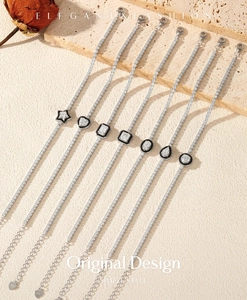 Macro detail of S925 silver tennis bracelets featuring black enamel and seven geometric charms