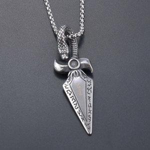 Detailed shot of silver stainless steel viking dagger pendant with snake carving