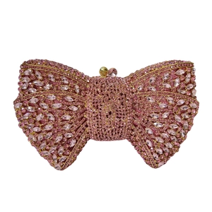 Pink rhinestone bow clutch bag with gold metal frame and spherical clasp for party