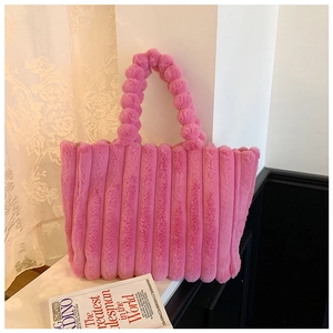 Detailed texture of pink plush handbag with vertical stripes and sphere-shaped handle
