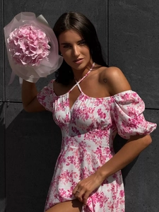 Detail of off-shoulder floral dress with puff sleeves and waist tie design