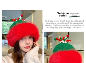 Detail of Christmas green knit hat with red faux fur brim and festive plush star ornament