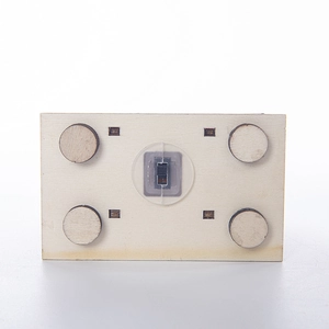 Detail of the bottom wooden base featuring a black electronic LED light switch component