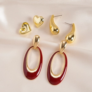 6-piece gold earrings set featuring heart, teardrop, and red enamel oval designs on silk