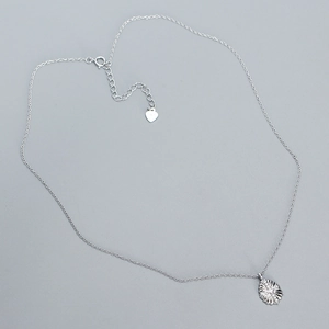 Detail showing the S925 silver hallmark on a heart tag and dainty silver chain link