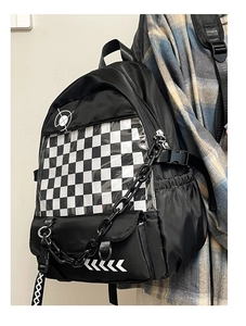 Detail view of black preppy backpack featuring checkerboard clear window and plastic chain