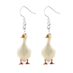 Close-up of cute white goose acrylic earrings with silver metal hooks on white background