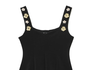 Detailed view of the black slim-fit top featuring 3D gold flowers and pearl embellishments