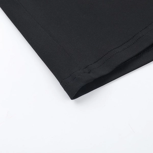 Detailed close-up showing the fine stitching and knit texture of the black mini dress