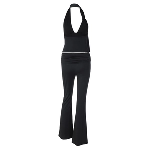 Detail of black halter neck top and flared pants set in elastic knit fabric
