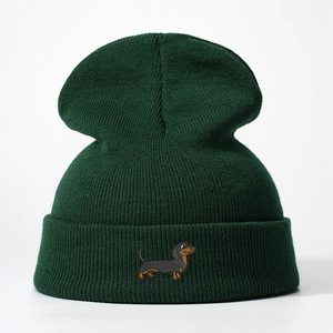 Dark green knitted beanie featuring a detailed dachshund embroidery on the folded cuff