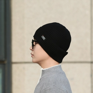 Classic black knitted beanie with ribbed texture and side label for winter warmth