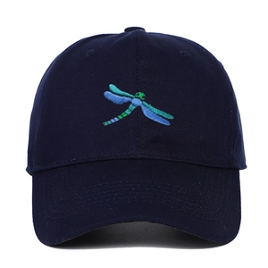 Detail of dragonfly embroidery on navy blue cotton baseball cap with curved brim