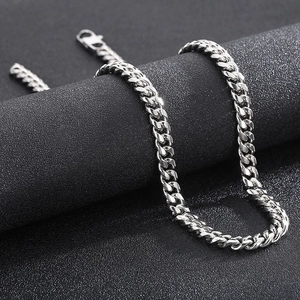 Macro shot of silver stainless steel Cuban link necklace with a secure lobster clasp