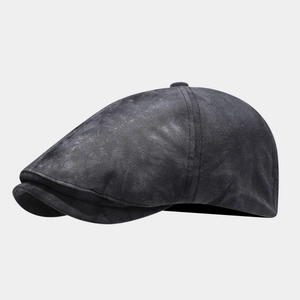 Detail of vintage washed dark grey newsboy cap showing cotton texture and stitching