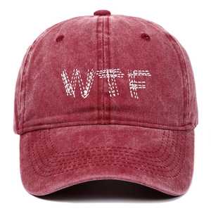 Detail of vintage washed cotton baseball cap with white WTF embroidered lettering