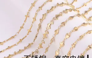 Macro shot of stainless steel vacuum plated gold chains with cross and heart charms