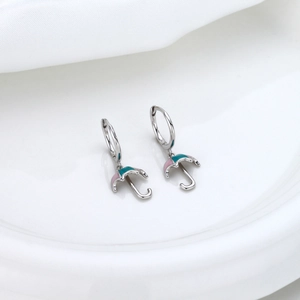 Close-up of S925 silver umbrella earrings with pink and green enamel detail