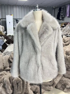 Détail du manteau en fausse fourrure grise avec col à revers et fibres longues et douces